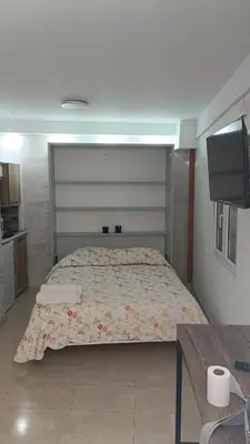 a large bed in a room with a tv at Estudio cerca de Oceanogràfic Valencia in Valencia