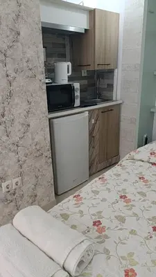 a kitchen with a microwave and a bed in a room at Estudio cerca de Oceanogràfic Valencia in Valencia
