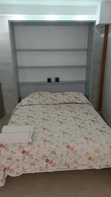 a bedroom with a bed with a floral bedspread at Estudio cerca de Oceanogràfic Valencia in Valencia