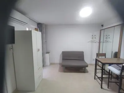 a living room with a chair and a table at Estudio cerca de Oceanogràfic Valencia in Valencia