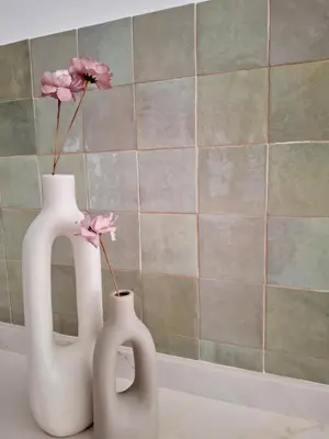 two white vases sitting on a counter with flowers in them at Bonito apartamento de 2 habitaciones cerca de la Estación Joaquín Sorolla in Valencia