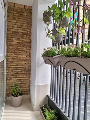 a balcony with potted plants on a railing at Bonito apartamento de 2 habitaciones cerca de la Estación Joaquín Sorolla in Valencia