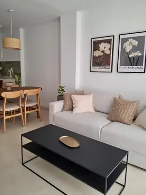 a living room with a couch and a table at Bonito apartamento de 2 habitaciones cerca de la Estación Joaquín Sorolla in Valencia