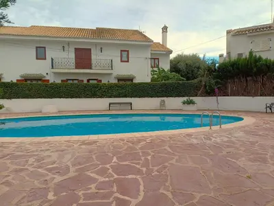 a swimming pool in front of a house at Play-Puig Beach Flat in El Puig