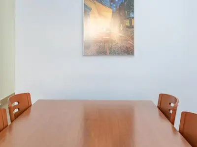 a table with two chairs and a picture on the wall at Montolivet Gulliver in Valencia