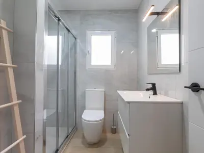 a bathroom with a toilet and a sink and a shower at Montolivet Gulliver in Valencia