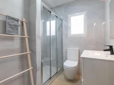 a bathroom with a shower and a toilet and a sink at Montolivet Gulliver in Valencia