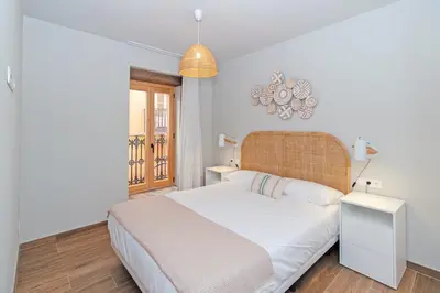 a bedroom with a white bed and a window at Maritime Apartamentos Puerto in Valencia