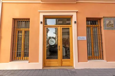 an orange building with a door with a sign on it at Maritime Apartamentos Puerto in Valencia
