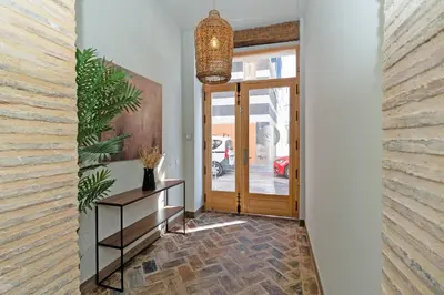 a hallway with a door and a pendant light at Maritime Apartamentos Puerto in Valencia