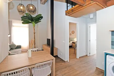 a kitchen and living room with a table and chairs at Maritime Apartamentos Puerto in Valencia