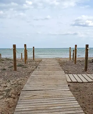 a wooden path leading to the beach at Apartamento a 60 metros de la Playa in Playa de Mar