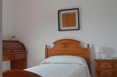 a bedroom with a bed and a picture on the wall at Apartamento a 60 metros de la Playa in Playa de Mar