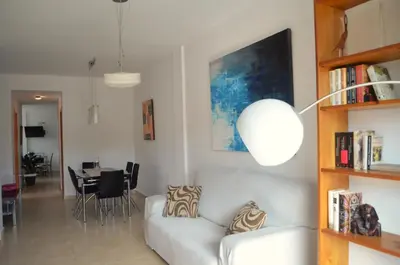 a living room with a white couch and a table at Apartamento a 60 metros de la Playa in Playa de Mar