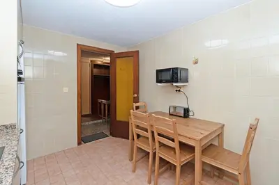 a dining room with a wooden table and chairs at GuestReady - Lindo piso muy espacioso en Valencia in Valencia