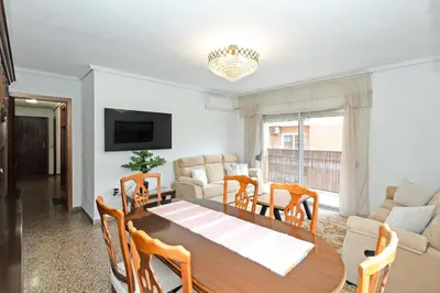 a dining room and living room with a table and chairs at GuestReady - Lindo piso muy espacioso en Valencia in Valencia