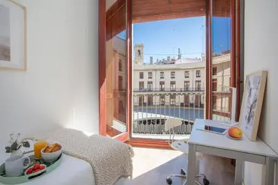 a room with a window with a view of a building at SingularStays Plaza Redonda II in Valencia