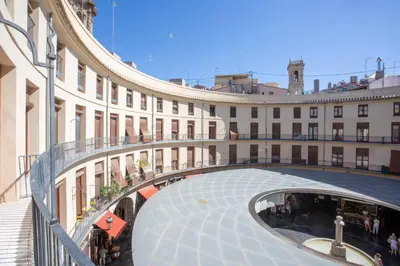 a large building with a walkway in front of it at SingularStays Plaza Redonda II in Valencia