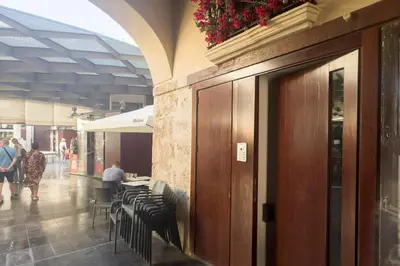 a restaurant with tables and chairs in a building at SingularStays Plaza Redonda II in Valencia