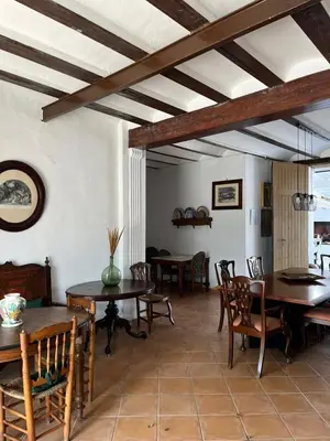 a dining room with wooden tables and chairs at Casa Rural Huerto del Carmen in Puebla Larga