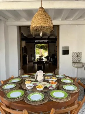 a dining room table with plates of food on it at Casa Rural Huerto del Carmen in Puebla Larga