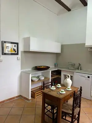 a kitchen with a wooden table with chairs and a table sidx sidx sidx at Casa Rural Huerto del Carmen in Puebla Larga