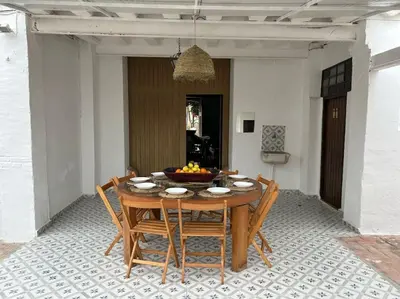 a wooden table with chairs and a bowl of fruit on it at Casa Rural Huerto del Carmen in Puebla Larga