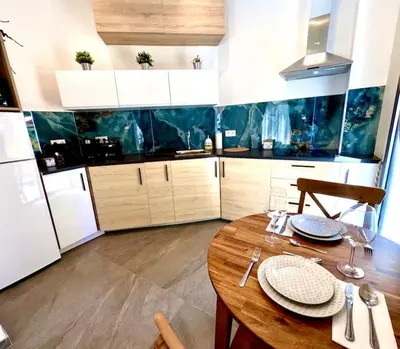 a kitchen with a wooden table with plates on it at Elegante y nuevo in Valencia