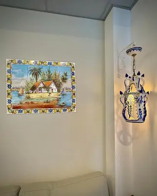 a painting hanging on a wall with a chandelier at Elegante y nuevo in Valencia