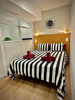 a bedroom with a black and white striped bed at Céntrico, coqueto y vintage in Valencia