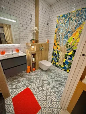 a bathroom with a sink and a toilet and a mosaic wall at Céntrico, coqueto y vintage in Valencia