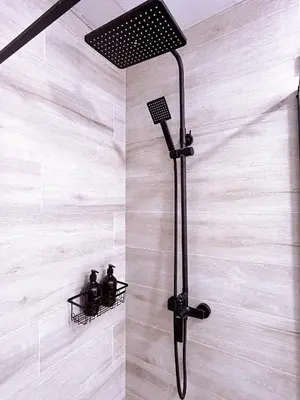 a shower in a bathroom with two bottles at La Brisa Lofts in Valencia