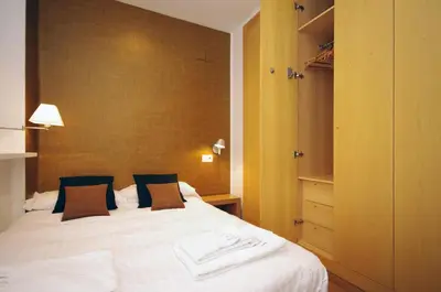 a bedroom with a large white bed and a closet at Vivaldi Penthouse Ayuntamiento in Valencia