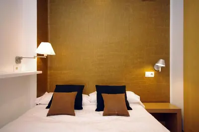 a bedroom with a white bed with two pillows at Vivaldi Penthouse Ayuntamiento in Valencia