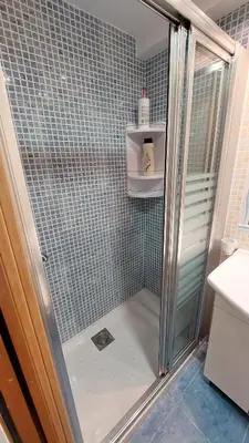 a shower with a glass door in a bathroom at Playa, relax y parking público cerca - Ideal parejas in Cullera
