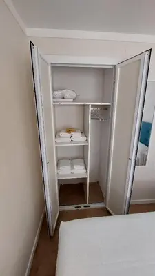 a white closet with a bed in a room at Playa, relax y parking público cerca - Ideal parejas in Cullera