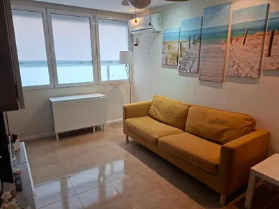 a living room with a couch and some windows at Playa, relax y parking público cerca - Ideal parejas in Cullera