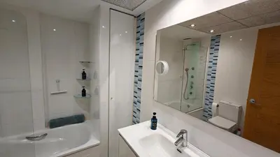 a white bathroom with a sink and a shower at Non Stress Seven Up in Valencia