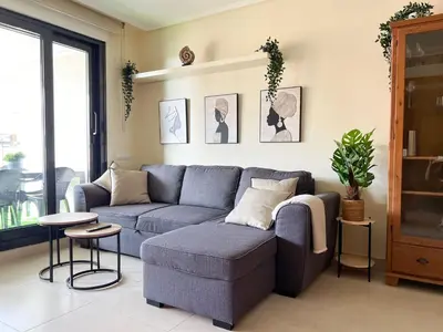 a living room with a blue couch and a table at Non Stress Seven Up in Valencia