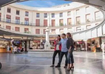 a group of people walking through a shopping mall at Ruzafa experience Oceanografic ciencias in Valencia