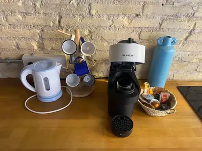a coffee maker and cups on a table at Ruzafa experience Oceanografic ciencias in Valencia