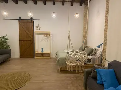 a living room with a bed and a swing at Ruzafa experience Oceanografic ciencias in Valencia