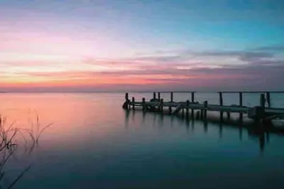 a dock on a body of water at sunset at Apto ruzafa patio center science oceanografic in Valencia