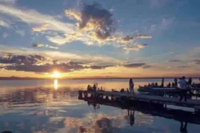 a group of people standing on a pier at sunset at Apto ruzafa patio center science oceanografic in Valencia