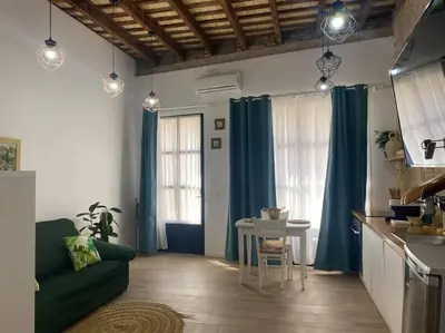 a living room with a green couch and a table at ruzafa oceanograf science center in Valencia