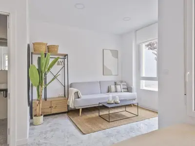 a living room with a couch and a table at Loft Temporal a 2 min de Playa de Sagunto A1 in Puerto de Sagunto