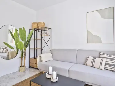 a living room with a couch and a table at Loft Temporal a 2 min de Playa de Sagunto A1 in Puerto de Sagunto