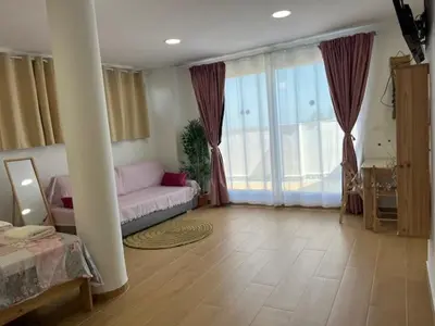 a living room with a couch and a large window at ALZIRA BONITA Apto con terraza y cama balinesa les barraques in Alzira