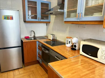 a kitchen with a stainless steel refrigerator and a microwave at Encantador piso en Benimaclet in Valencia