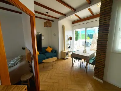 a living room with a blue couch and a table at Encantador piso en Benimaclet in Valencia